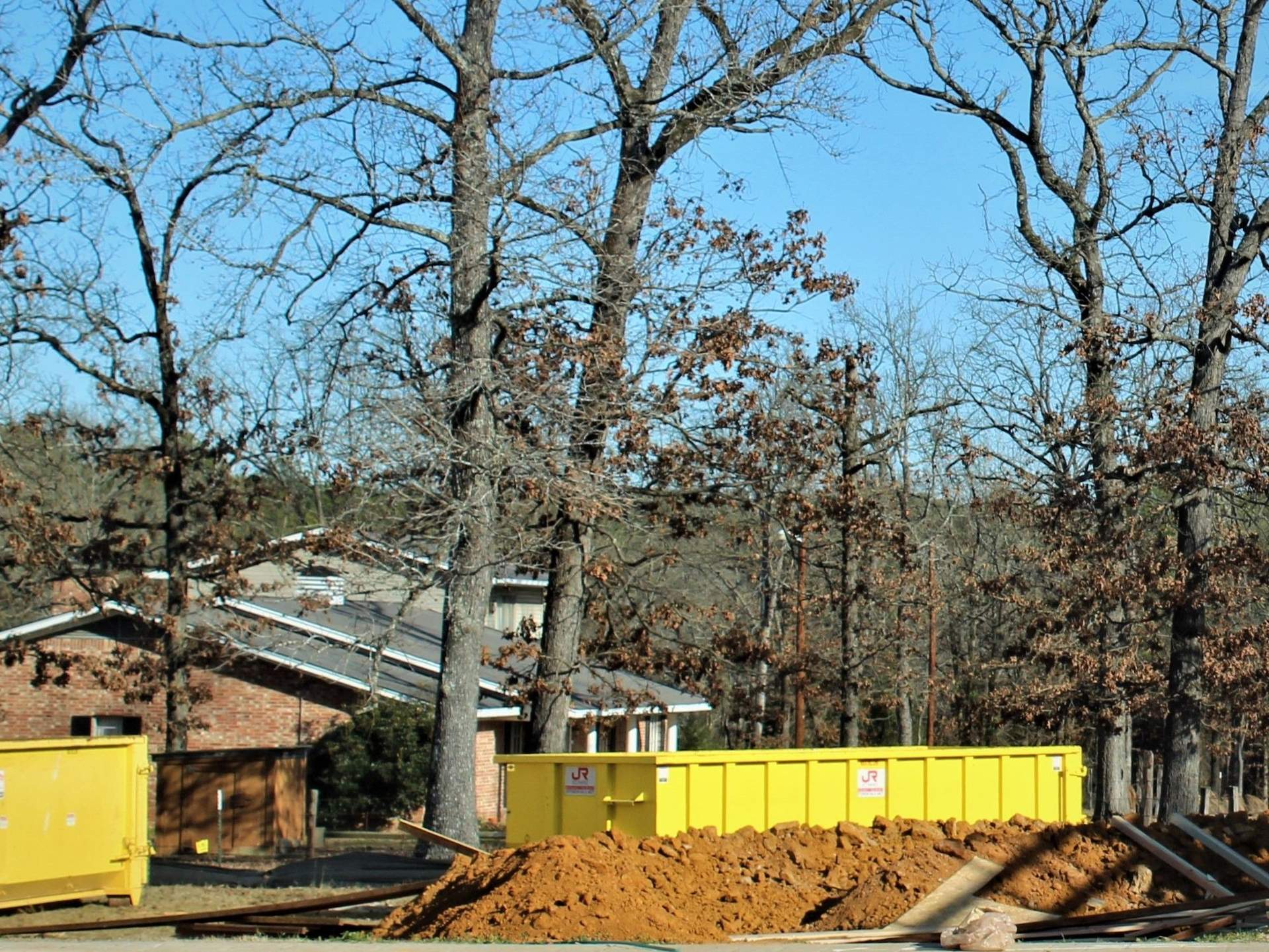 JOTS Rentals portable restroom and dumpster on an active construction site
