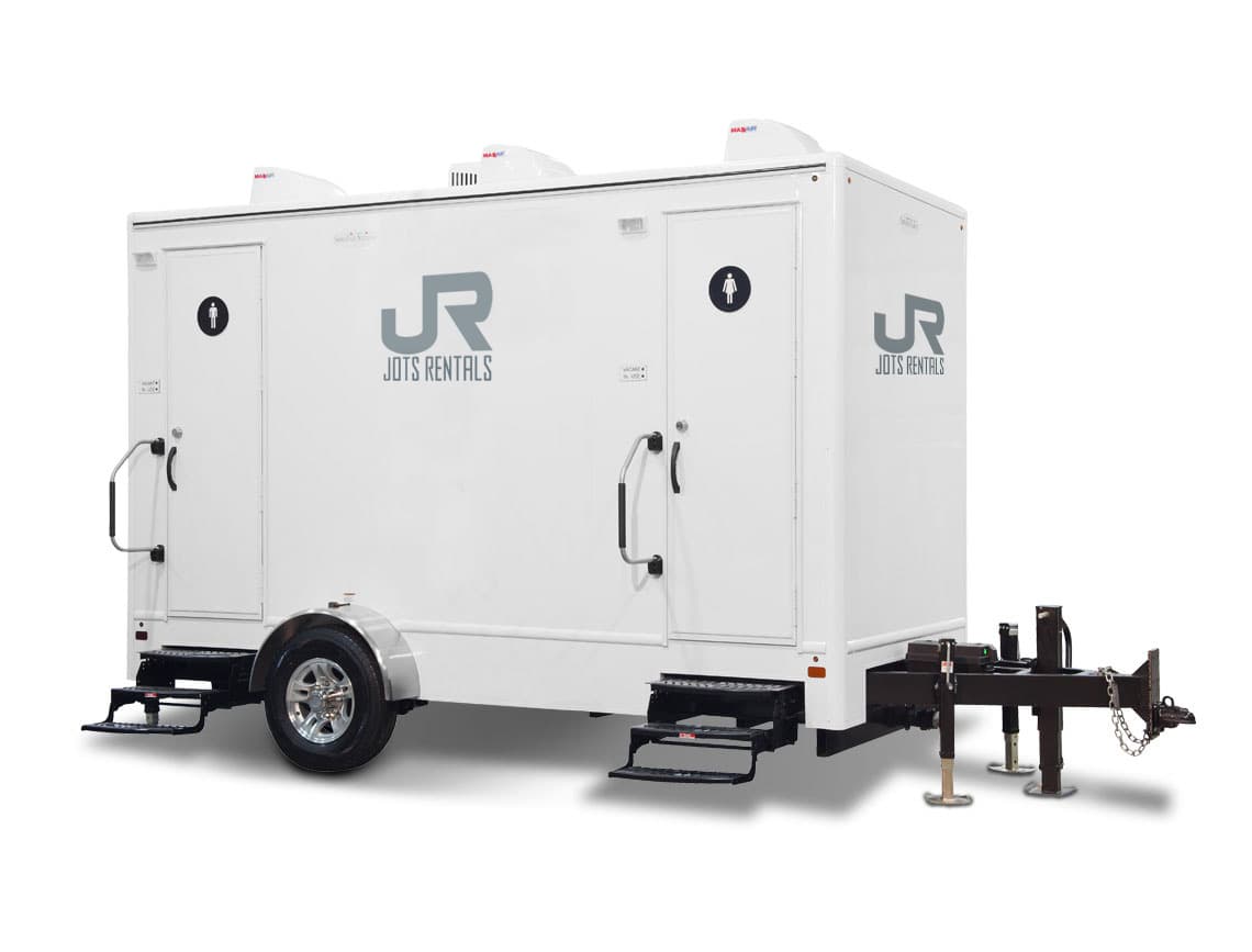 JOTS Rentals four-stall satellite restroom unit set up for an event