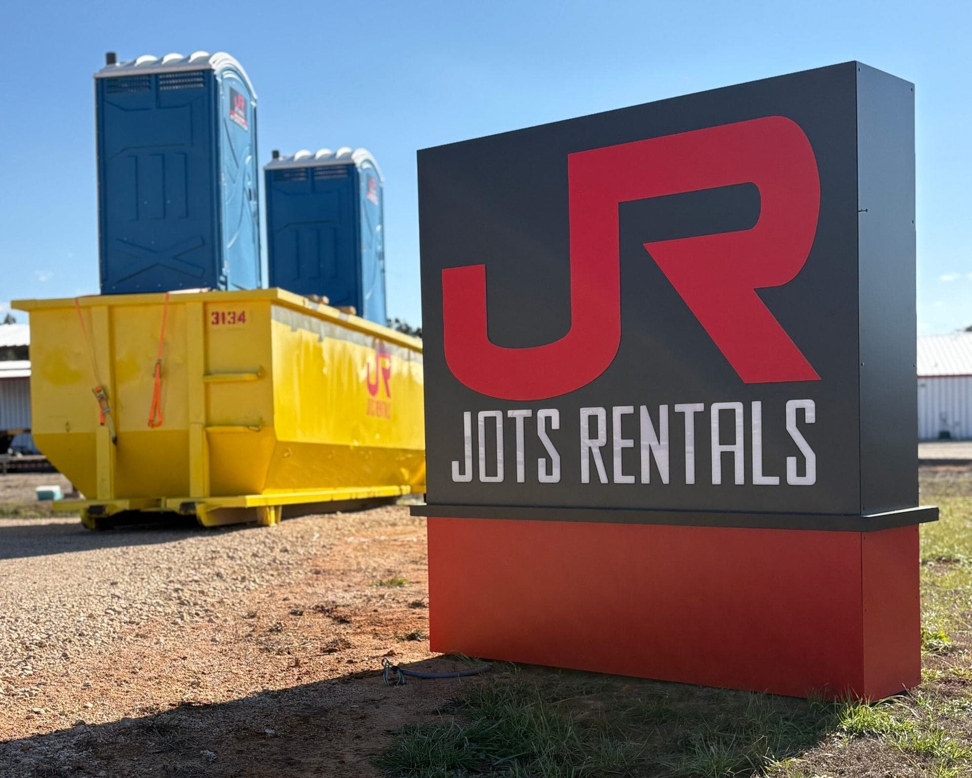 JOTS Rentals portable restroom and roll-off dumpster on site