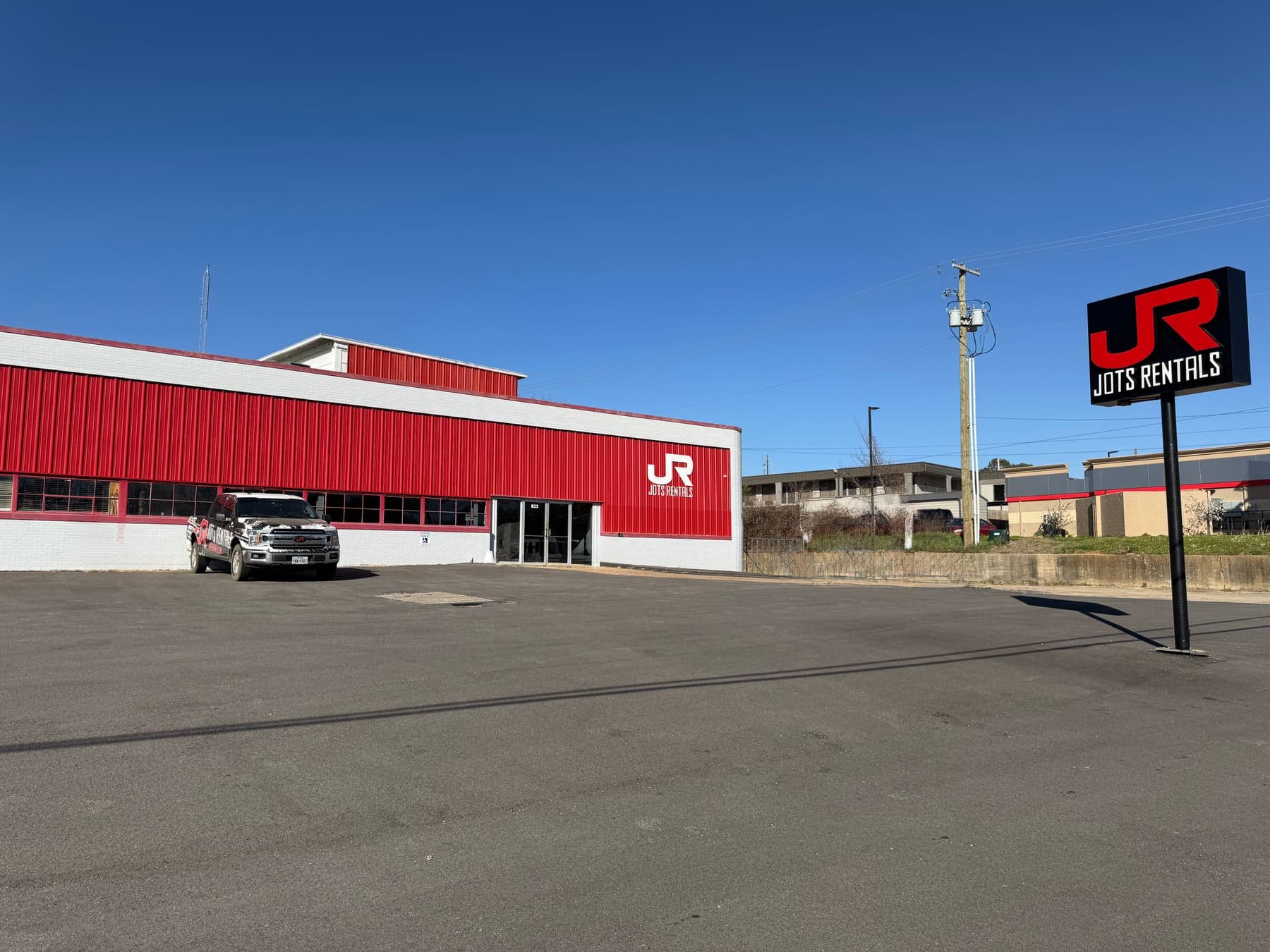 The JOTS Rentals Longview yard on West Marshall Avenue, with the road sign out front
